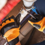 Caucasian,Plumber,Worker,Wearing,Safety,Gloves,Adjusting,Water,And,Sewage