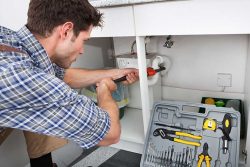 plumber fixing sink